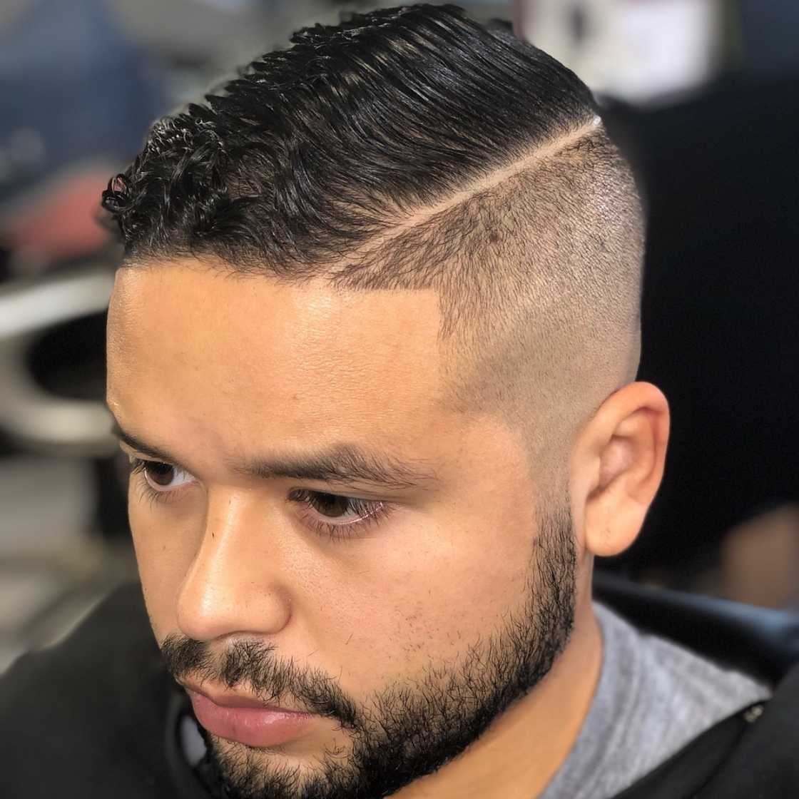 High bald fade with a comb over and hard part!