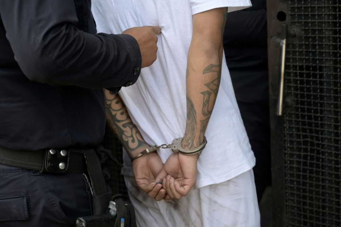 A man captured for alleged gang links is escorted by the National Civil Police during the state of emergency declared by the government in San Salvador on March 31, 2022 A man captured for alleged gang links is escorted by the National Civil Police during the state of emergency declared by the government in San Salvador on March 31, 2022