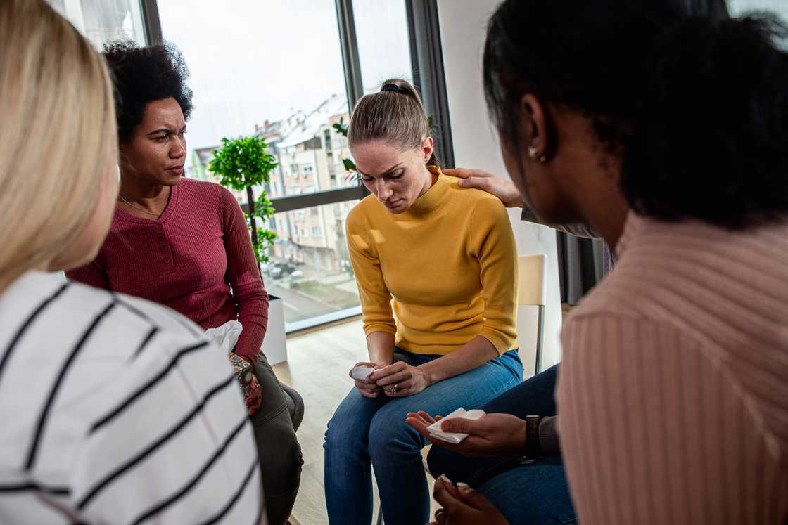 A group meeting in a living room.