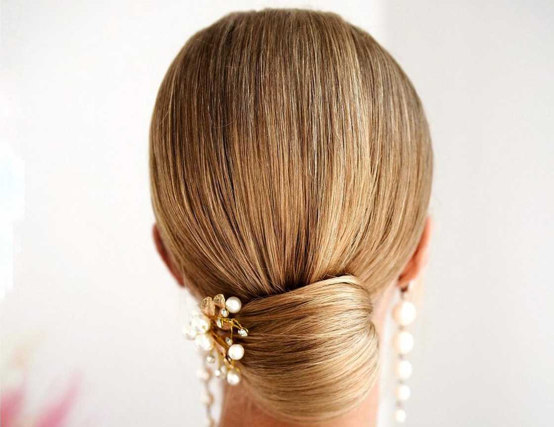 Low wedding bun with white accessories