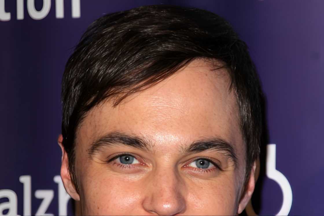 A man is wearing a short hair with a side part style A man is wearing a short hair with a side part style