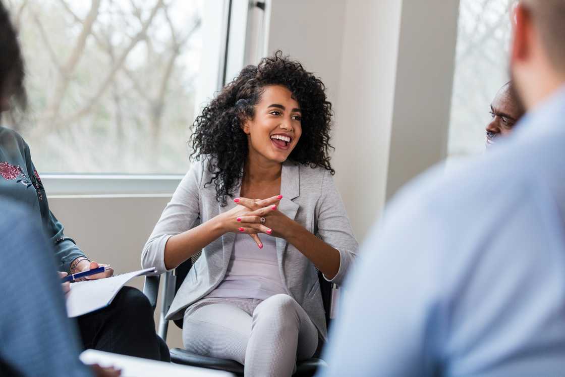 Smiling woman laughing joyfully in a therapy session Smiling woman laughing joyfully in a therapy session