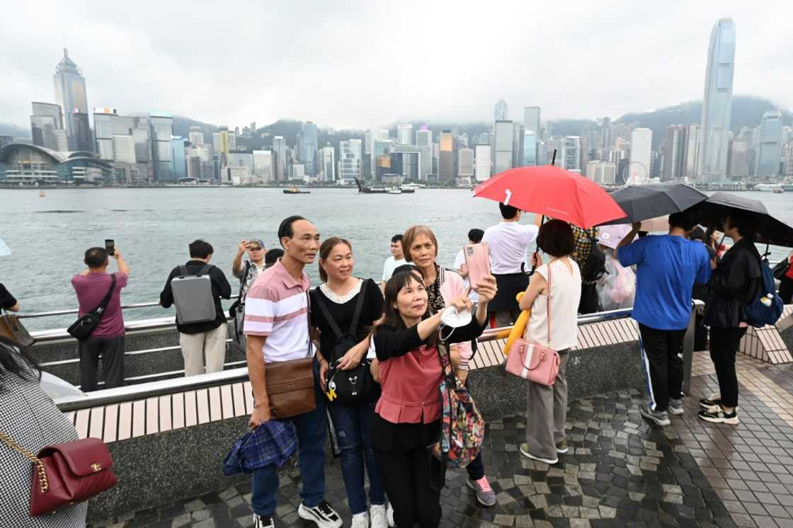 Tourists from mainland China visit the Tsim Sha Tsui waterfront in Hong Kong on May 1, the start of the 'Golden Week' holiday Tourists from mainland China visit the Tsim Sha Tsui waterfront in Hong Kong on May 1, the start of the 'Golden Week' holiday