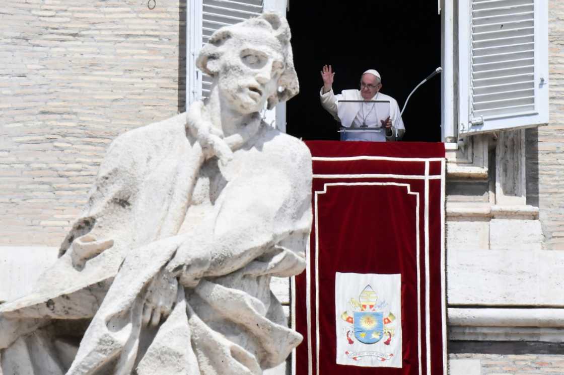 Pope Francis waves from the window of the apostolic palace on August 21, 2022 during the weekly Angelus prayer in The Vatican.