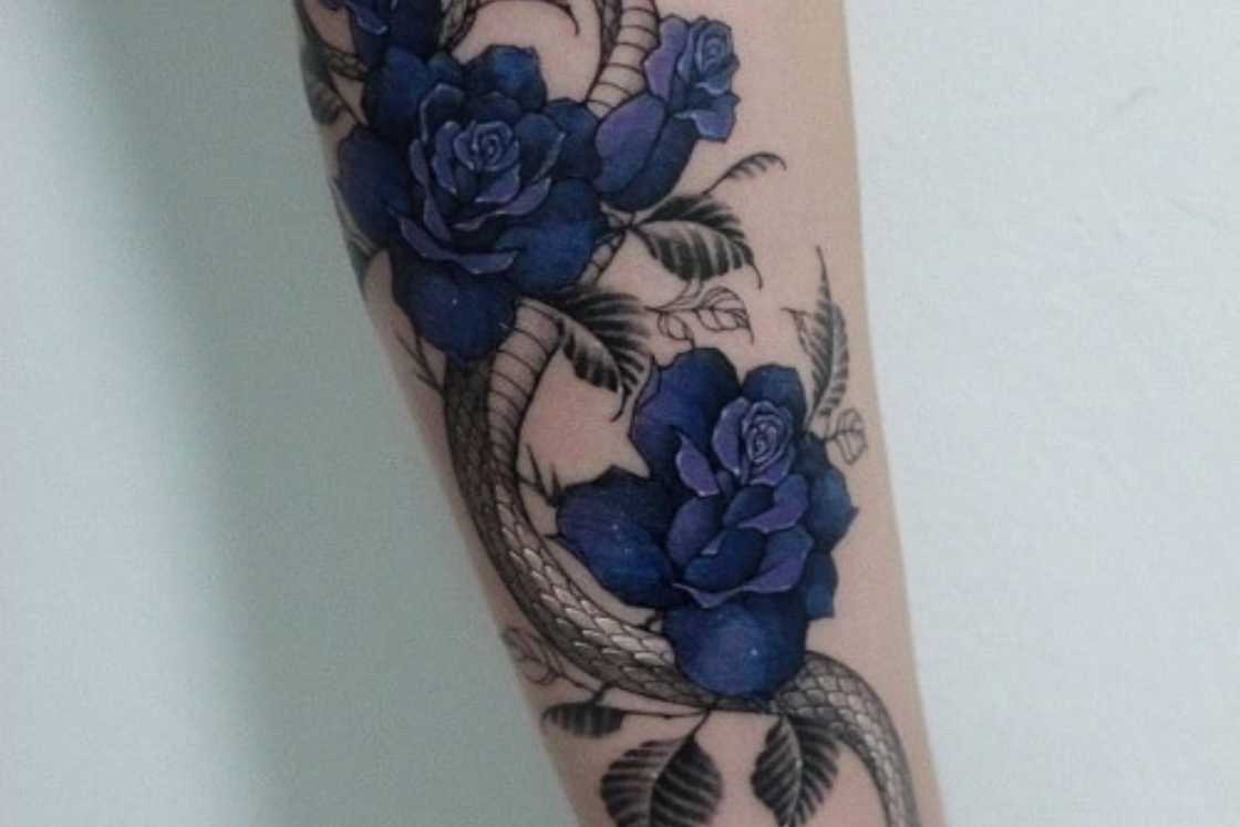 An intricate tattoo featuring blue roses An intricate tattoo featuring blue roses