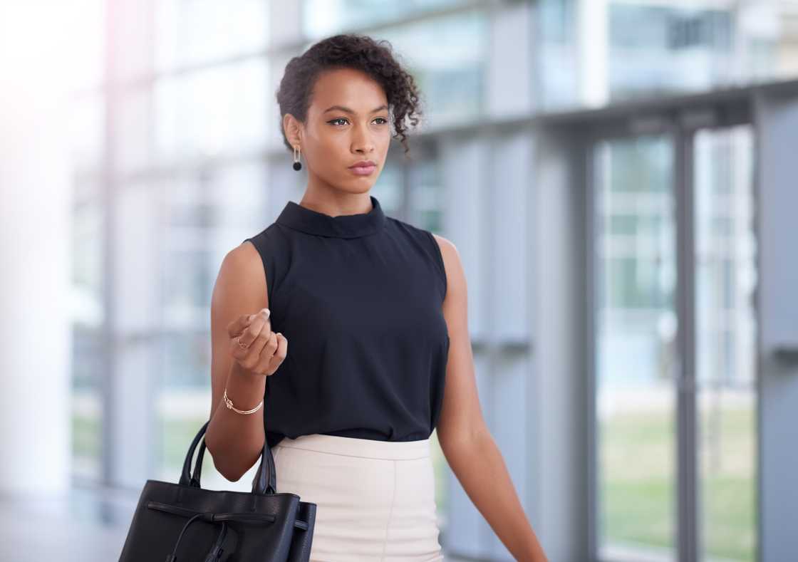 A confident young woman walking through a corridor A confident young woman walking through a corridor