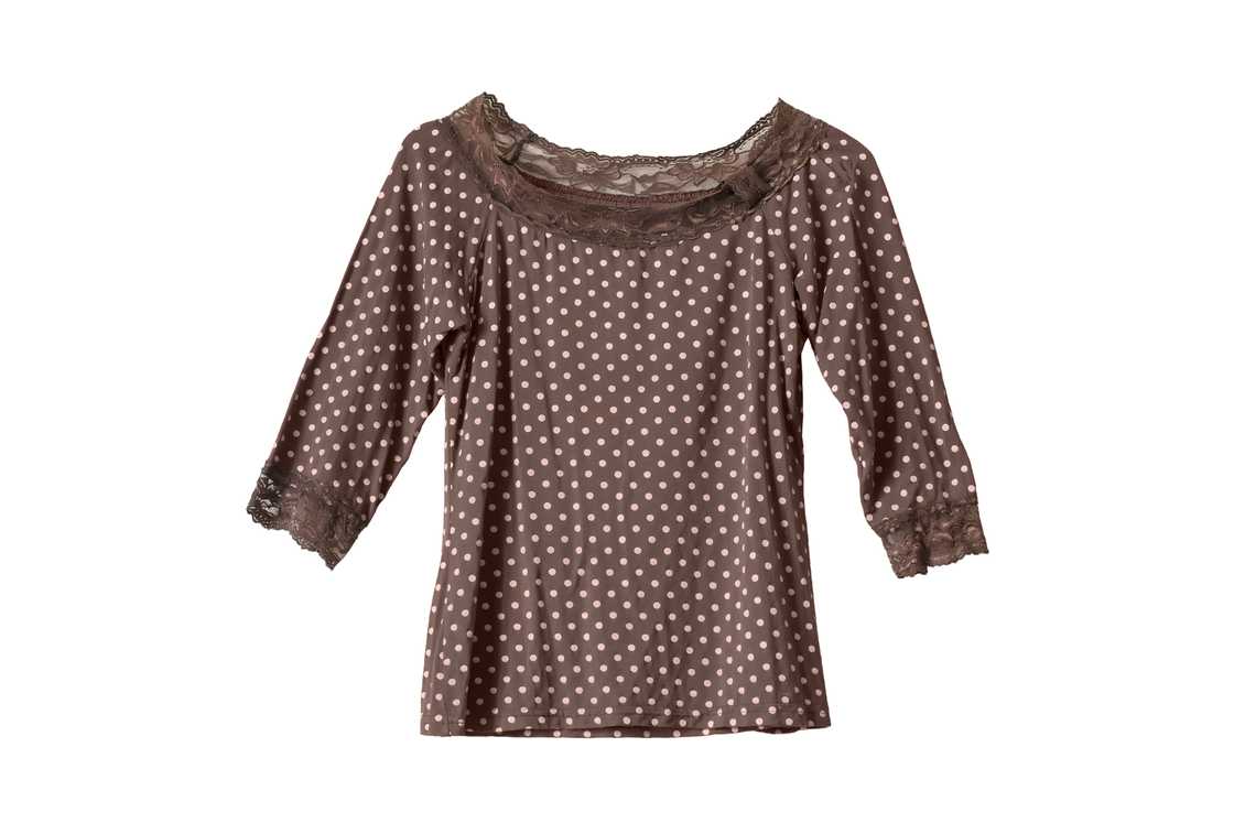 Brown spotted blouse decorated with lace on a white background Brown spotted blouse decorated with lace on a white background