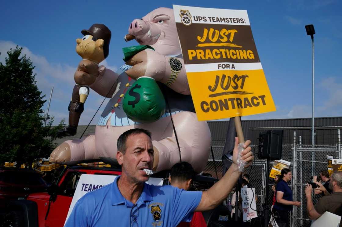 United Parcel Services (UPS) workers walk a 'practice picket line' on July 7, 2023, in the Queens borough of New York City, ahead of a possible UPS strike