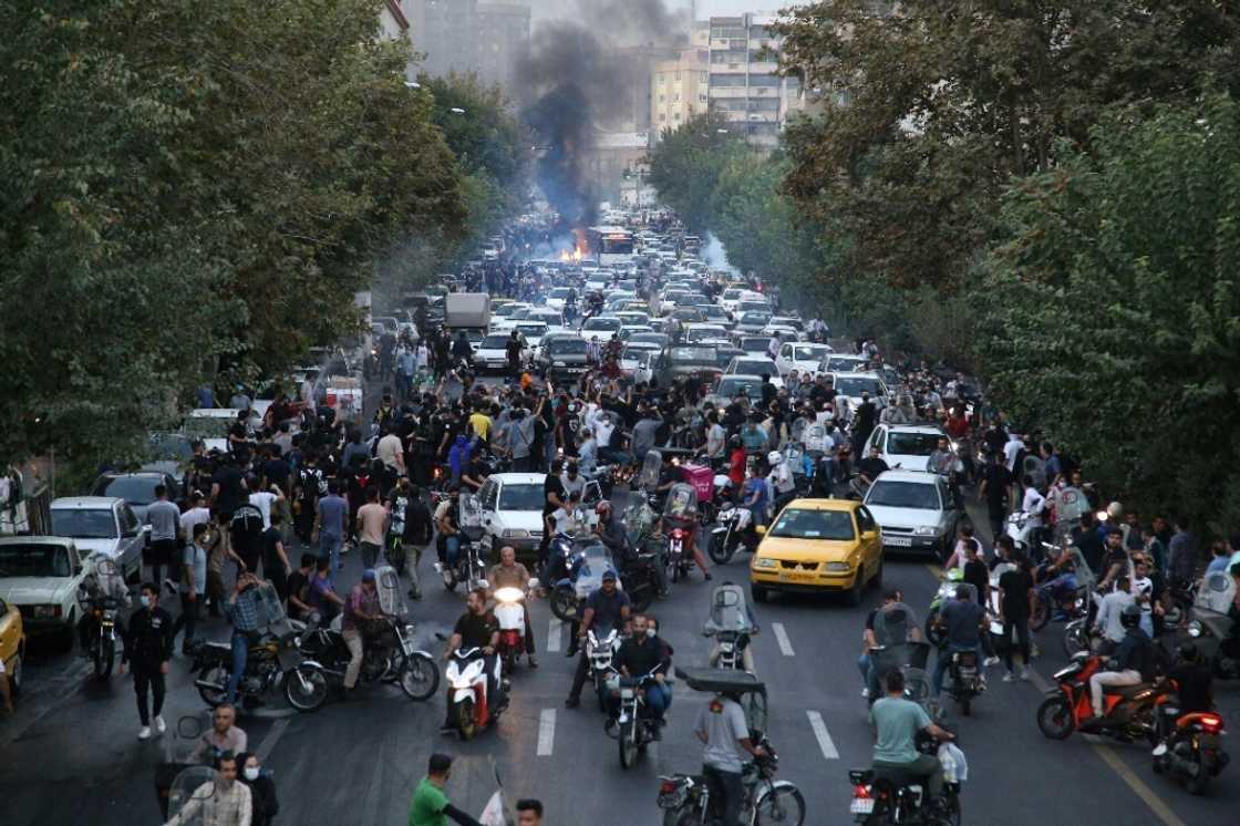 Demonstrators are seen taking to a street in the Iranian capital Tehran on September 21, 2022 Demonstrators are seen taking to a street in the Iranian capital Tehran on September 21, 2022