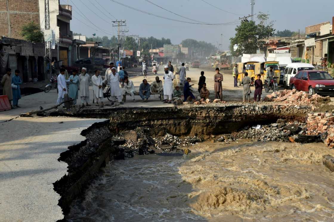 A family wades through a flood-hit area following heavy monsoon rains in Charsadda district of Khyber Pakhtunkhwa A family wades through a flood-hit area following heavy monsoon rains in Charsadda district of Khyber Pakhtunkhwa