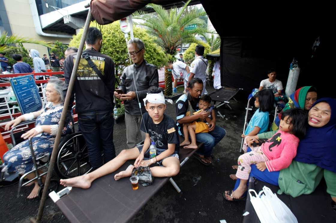 Wounded people rest under a tent displayed outside a hospital following an earthquake in Cianjur Wounded people rest under a tent displayed outside a hospital following an earthquake in Cianjur