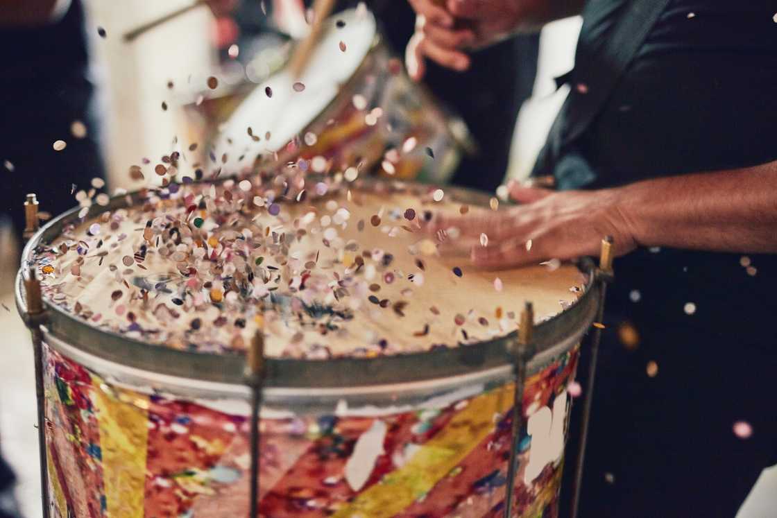 A musical performer playing drums