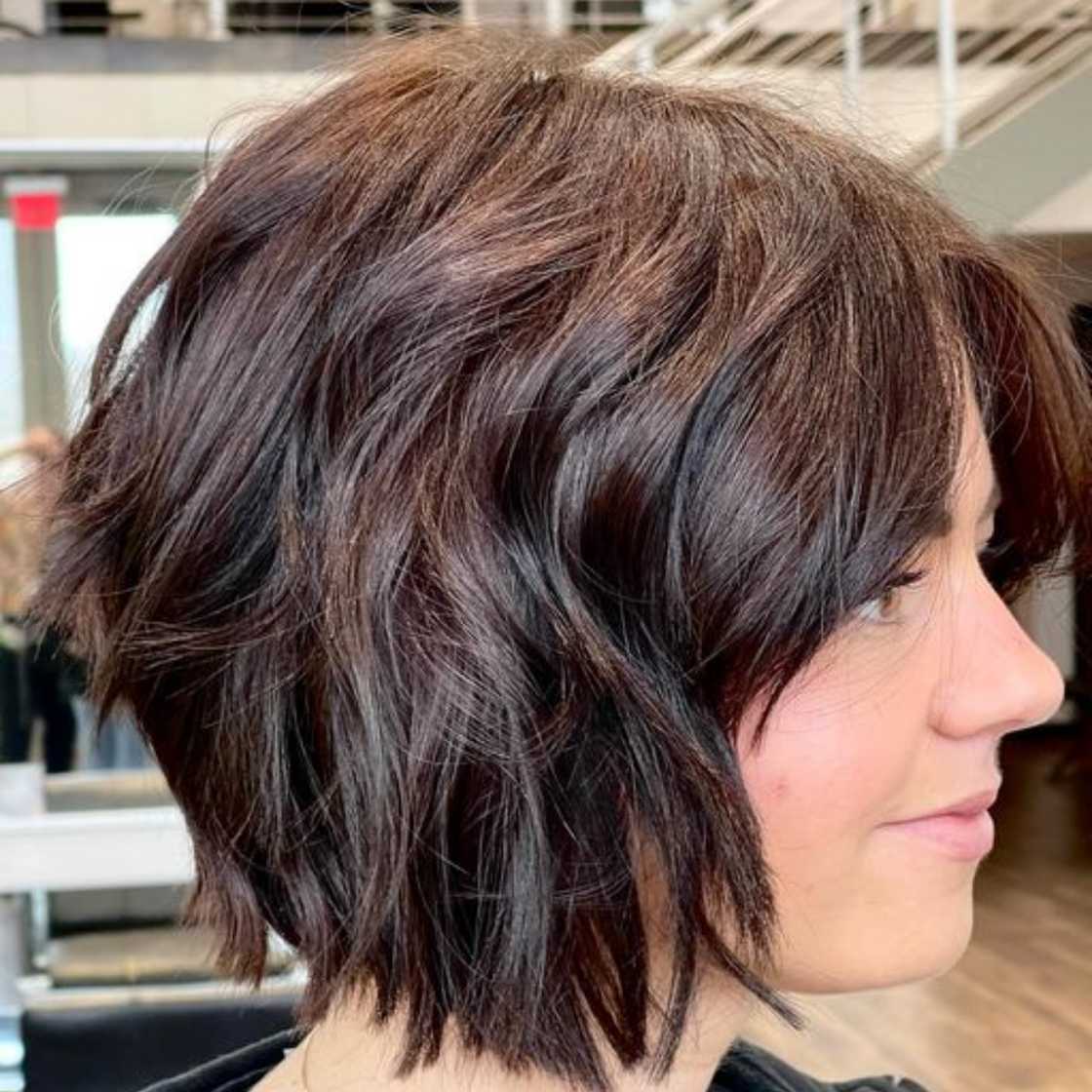 A white lady with a dark brown textured bob hairstyle