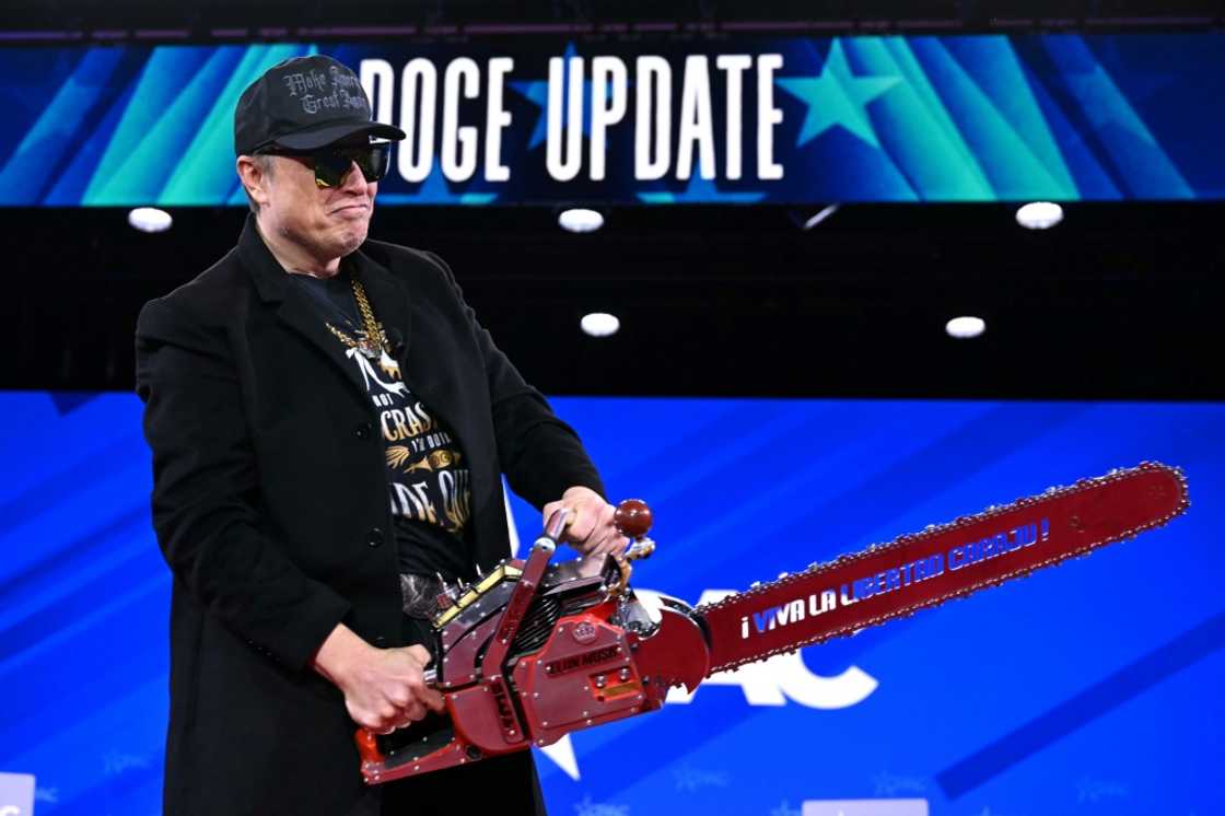 He brandished a chainsaw in reference to the cuts he is making to US federal services He brandished a chainsaw in reference to the cuts he is making to US federal services