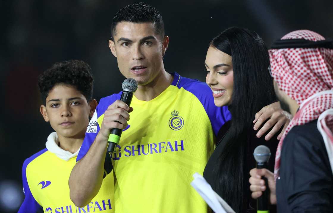 Cristiano Ronaldo (C-L), accompanied by his partner Georgina Rodriguez (C-R) and his son Cristiano Ronaldo Jr, greets the crowd at the Mrsool Park Stadium in the Saudi capital Riyadh on January 3, 2023, upon his presentation as an Al-Nassr player Cristiano Ronaldo (C-L), accompanied by his partner Georgina Rodriguez (C-R) and his son Cristiano Ronaldo Jr, greets the crowd at the Mrsool Park Stadium in the Saudi capital Riyadh on January 3, 2023, upon his presentation as an Al-Nassr player