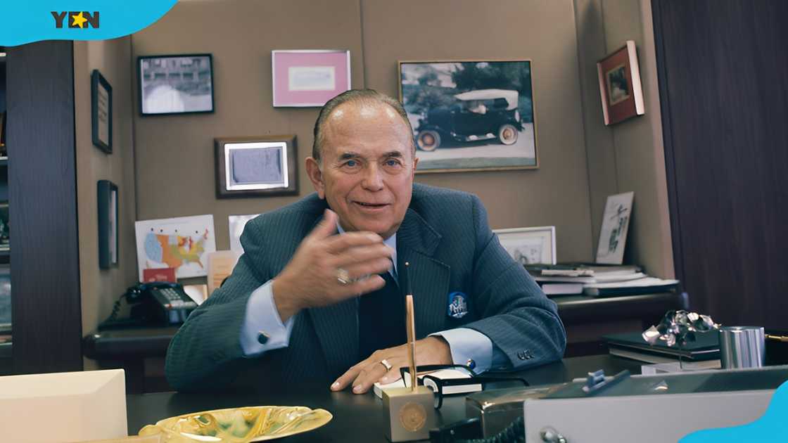 American businessman Ray Kroc seated in his office