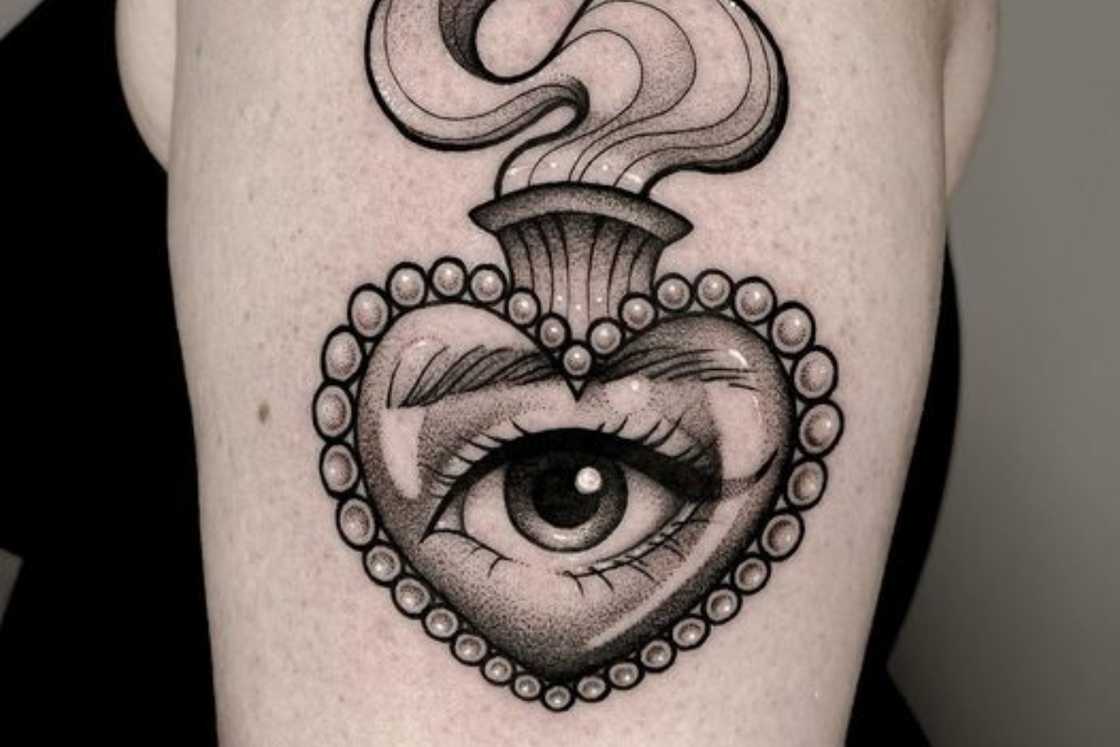 Upper arm Sacred Heart with eye tattoo