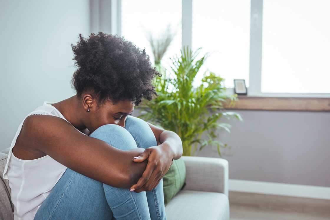 A lady is crying on the sofa A lady is crying on the sofa