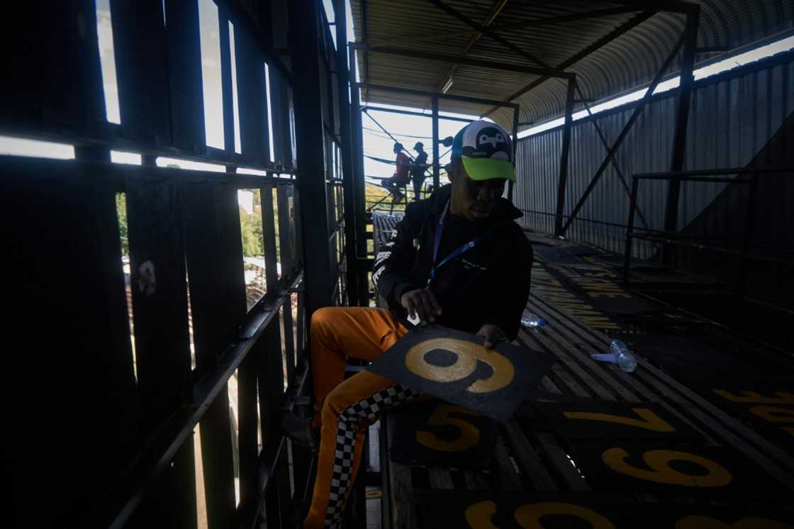 Scoreboard operator Zenzele Ndebele swaps numbers from within the manual scoreboard at Queens Sports Club in Bulawayo Scoreboard operator Zenzele Ndebele swaps numbers from within the manual scoreboard at Queens Sports Club in Bulawayo