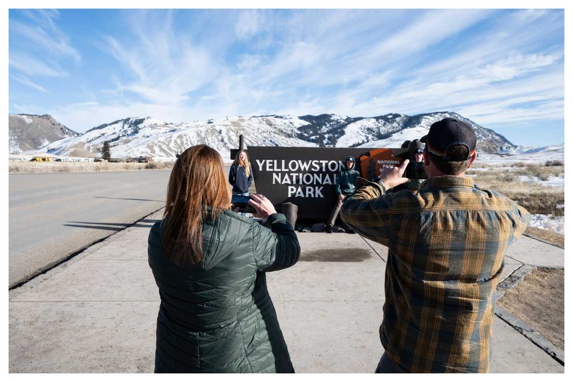 Visitors take photos at the northern entrance to Yellowstone National Park in Gardiner, Montana. Visitors take photos at the northern entrance to Yellowstone National Park in Gardiner, Montana.
