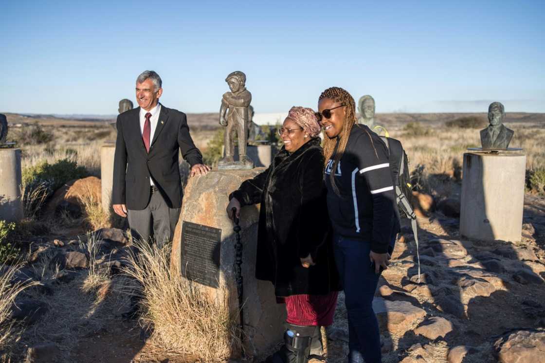 VIP guests Gaboilelwe Moroka and Bhelekazi Mabandla, centre and right, view Orania's Afrikaner statues. On the left is Louis Bothma, a historian and part of the welcoming committee