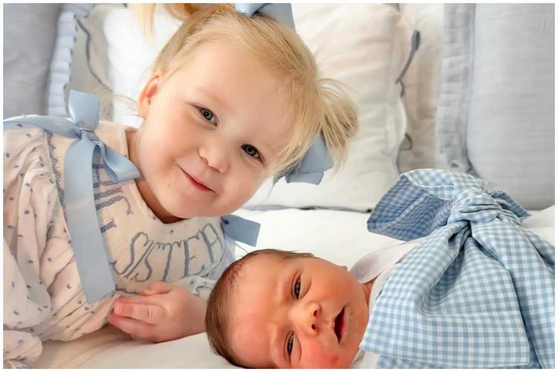 Bridget Blake Doocy and George Jack playing on bed.