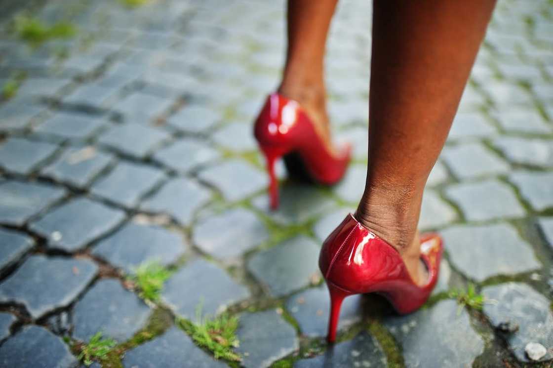 A photo of legs in stilettos. A photo of legs in stilettos.