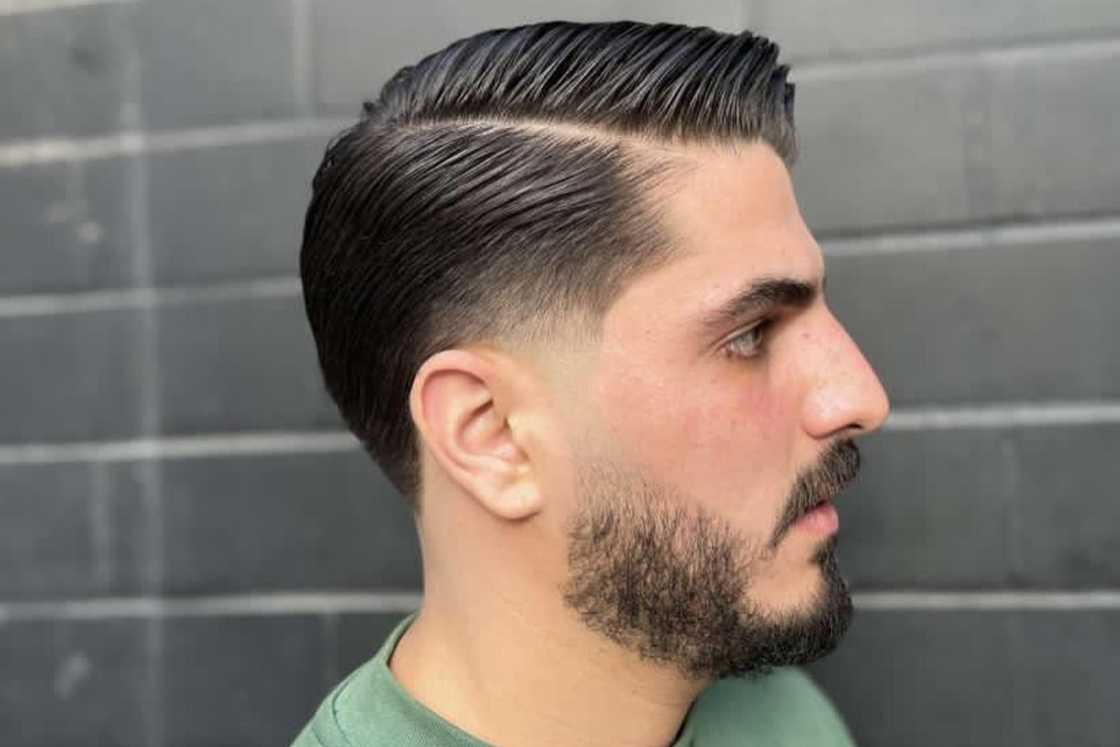 A man is rocking beard fade with low fade hairstyle