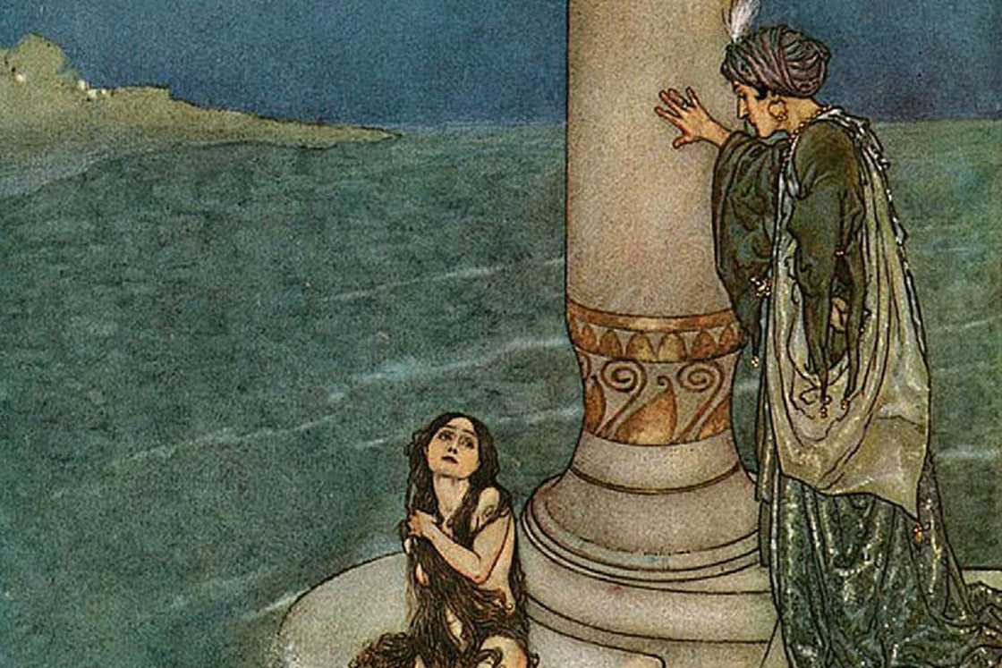 The Little Mermaid with dark hair covering her chest, sitting on a stone dock The Little Mermaid with dark hair covering her chest, sitting on a stone dock