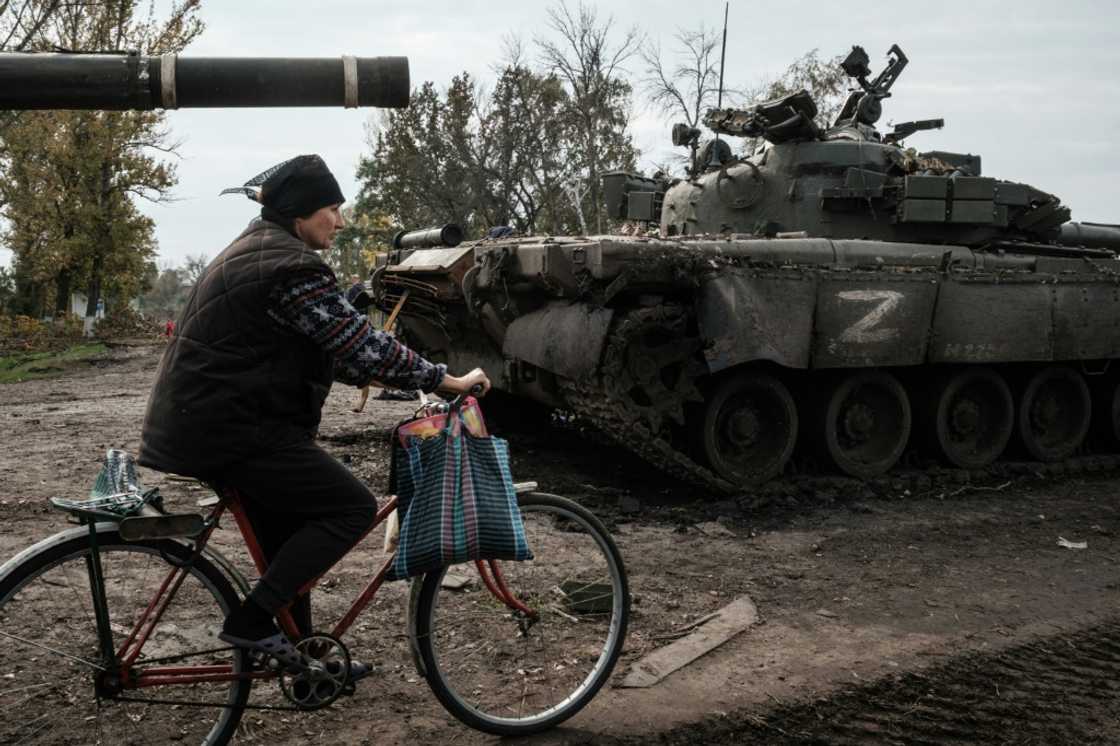 A local resident rides past an abandoned Russian tank marked Z near Kharkiv in Ukraine on September 30, 2022 A local resident rides past an abandoned Russian tank marked Z near Kharkiv in Ukraine on September 30, 2022