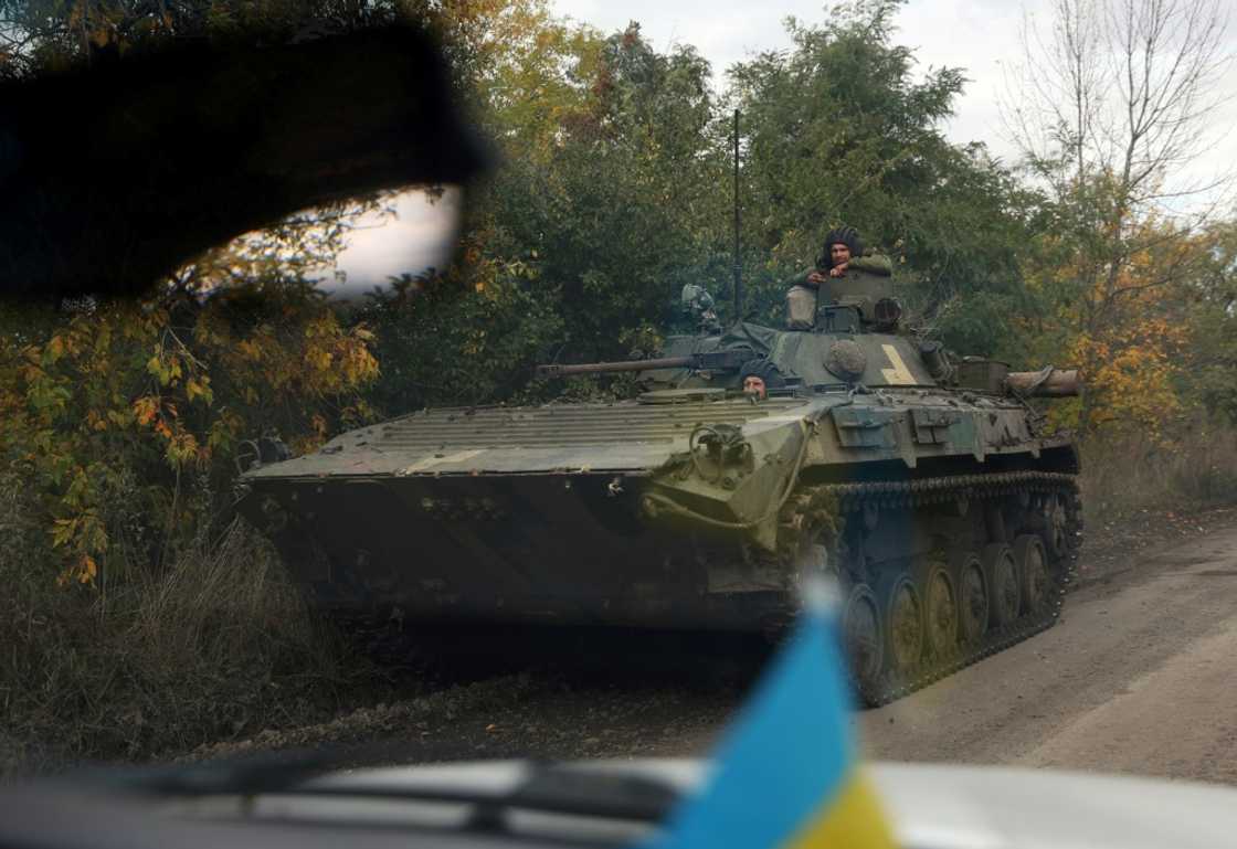 Ukrainian soldiers ride an armoured personnel carrier down a road in the Donetsk region Ukrainian soldiers ride an armoured personnel carrier down a road in the Donetsk region