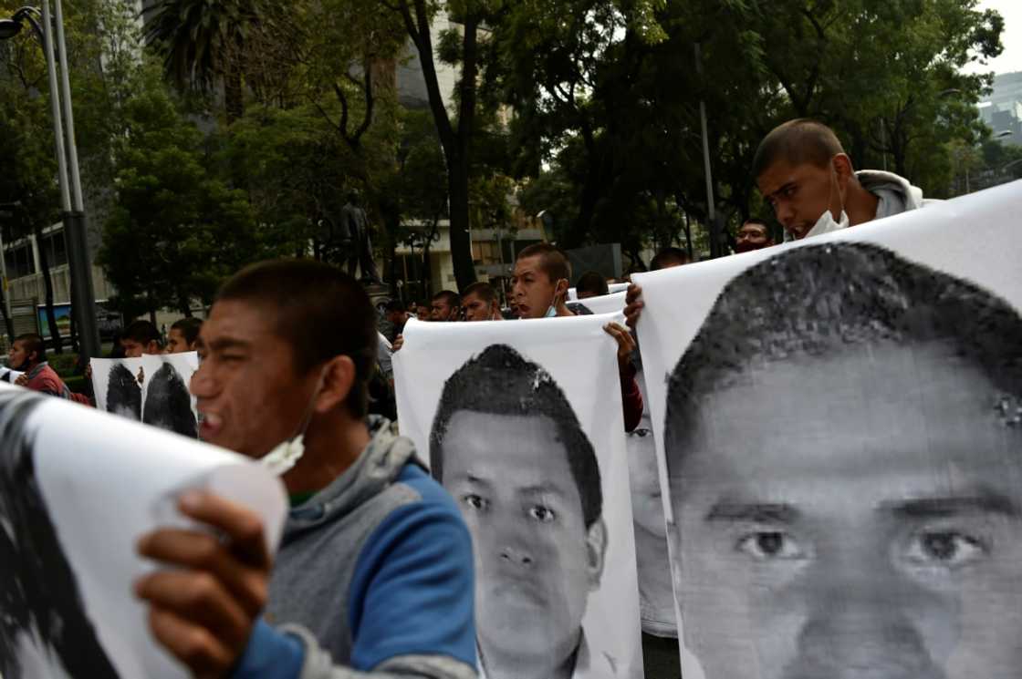 Protesters march in Mexico City in September 2020 carrying photos of the 43 students who disappeared in 2014 Protesters march in Mexico City in September 2020 carrying photos of the 43 students who disappeared in 2014