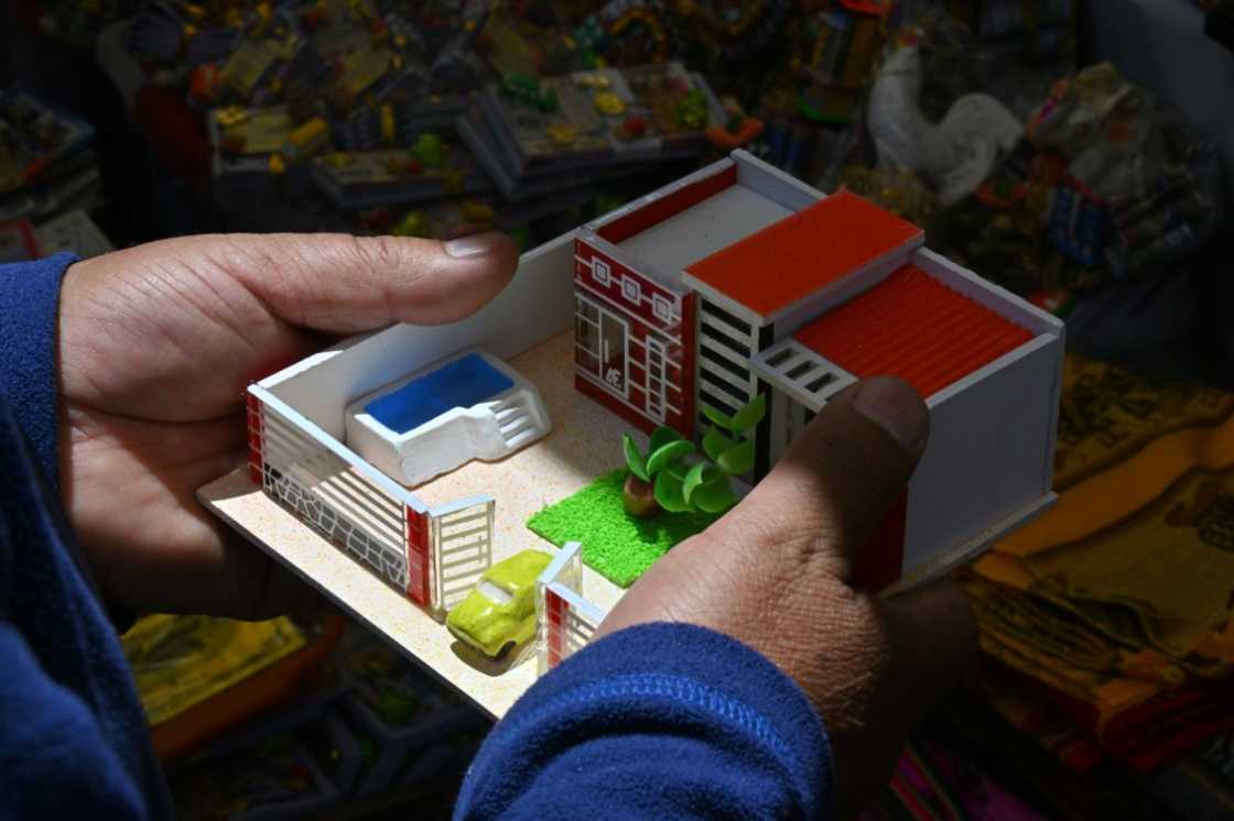 There are miniature houses too, such as this one complete with a patch of lawn, a car and a pool There are miniature houses too, such as this one complete with a patch of lawn, a car and a pool