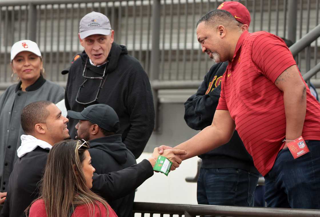 General Manager Ryan Poles of the Chicago Bears, left, meets with Carl Williams, father of Caleb Williams, during USC Pro Day.