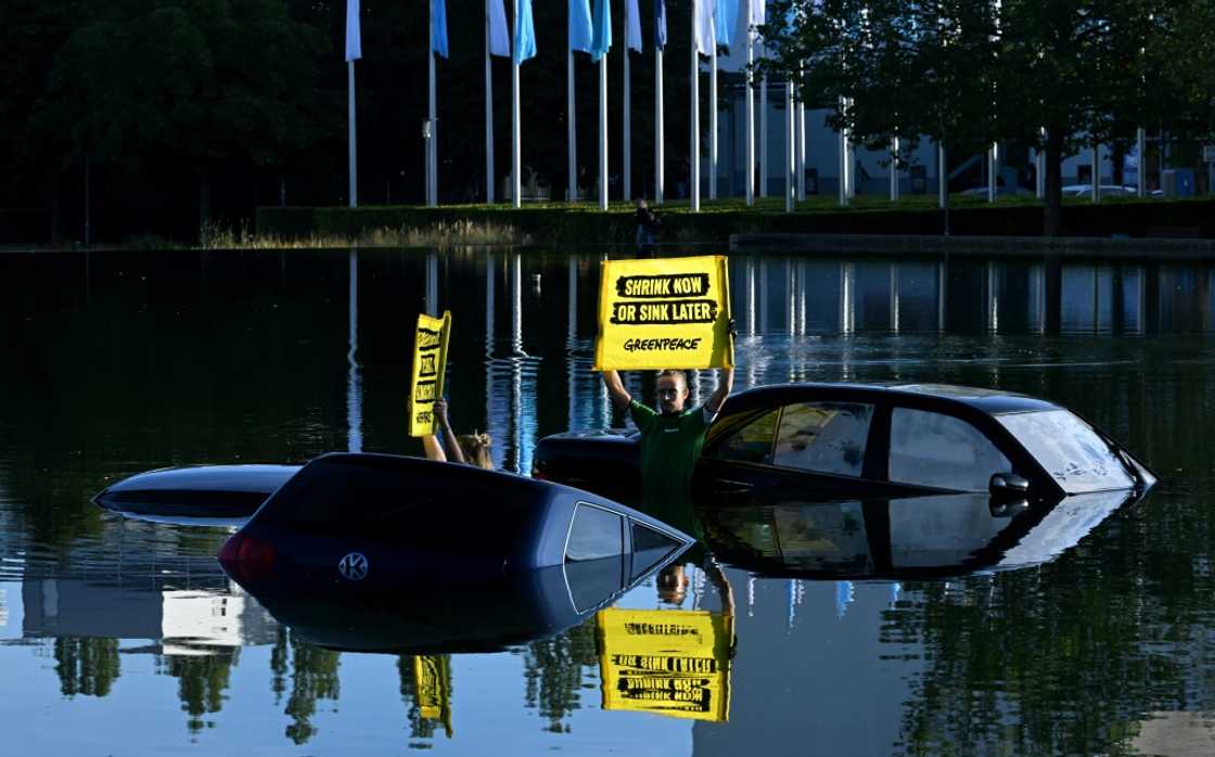 Greenpeace activists submerged three cars in a small lake outside the IAA convention centre Greenpeace activists submerged three cars in a small lake outside the IAA convention centre