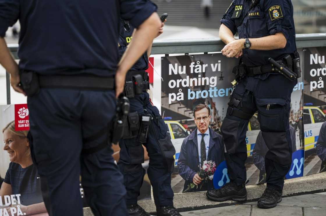 Police officers stand next to election posters in Stockholm. Sweden has struggled to combat escalating gang shootings attributed to battles over the drugs and weapons market Police officers stand next to election posters in Stockholm. Sweden has struggled to combat escalating gang shootings attributed to battles over the drugs and weapons market