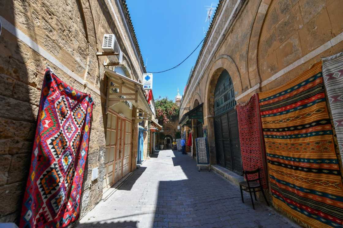 Traditional carpets displayed on the walls around a shop in the ninth-century medina, one of the first cities built after the Muslim conquests of North Africa Traditional carpets displayed on the walls around a shop in the ninth-century medina, one of the first cities built after the Muslim conquests of North Africa