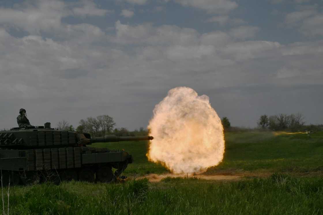 A tank crew of the Ukrainian 33rd Separate Mechanized Brigade fire a round from a Leopard 2A4 tank during a field training exercise at an undisclosed location in Ukraine