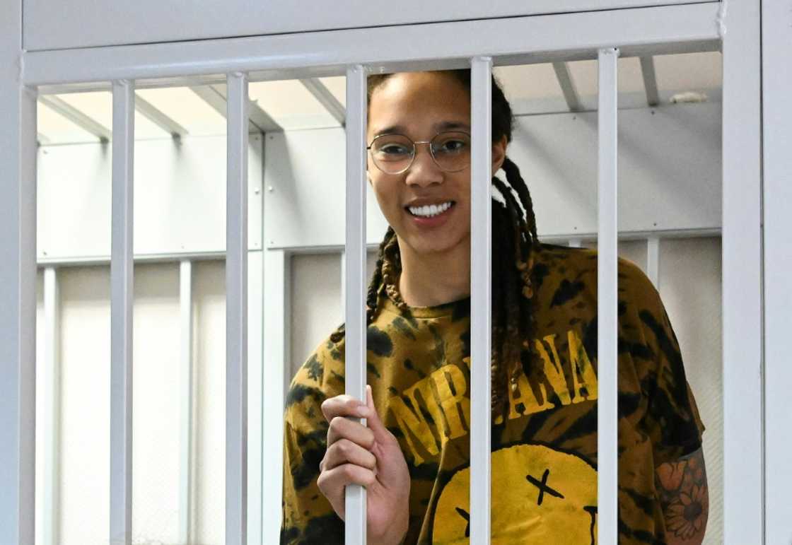US WNBA basketball superstar Brittney Griner smiles inside a defendants' cage during a hearing in the town of Khimki outside Moscow on July 15, 2022 US WNBA basketball superstar Brittney Griner smiles inside a defendants' cage during a hearing in the town of Khimki outside Moscow on July 15, 2022