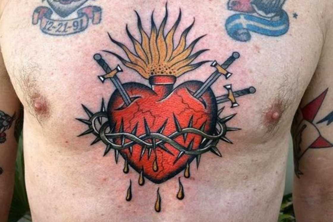 Sacred Heart chest tattoo with swords and thorns Sacred Heart chest tattoo with swords and thorns