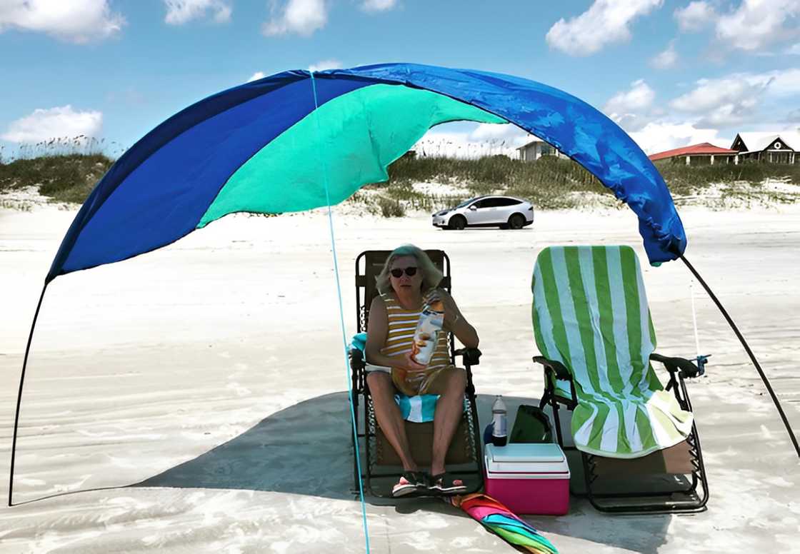 An old woman under a sunshade