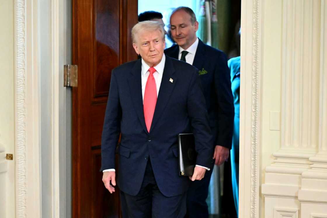 US President Donald Trump and Irish Prime Minister Micheal Martin (back) arrive for a St. Patrick's Day Reception in the White House US President Donald Trump and Irish Prime Minister Micheal Martin (back) arrive for a St. Patrick's Day Reception in the White House
