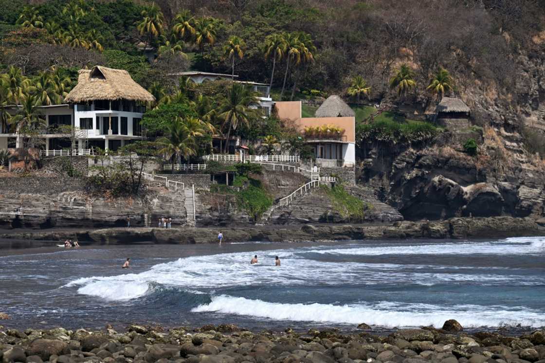 Tourists bathe at the Salvadoran beach town of El Zonte, known as 'Bitcoin Beach' for its embrace of the cryptocurrency Tourists bathe at the Salvadoran beach town of El Zonte, known as 'Bitcoin Beach' for its embrace of the cryptocurrency
