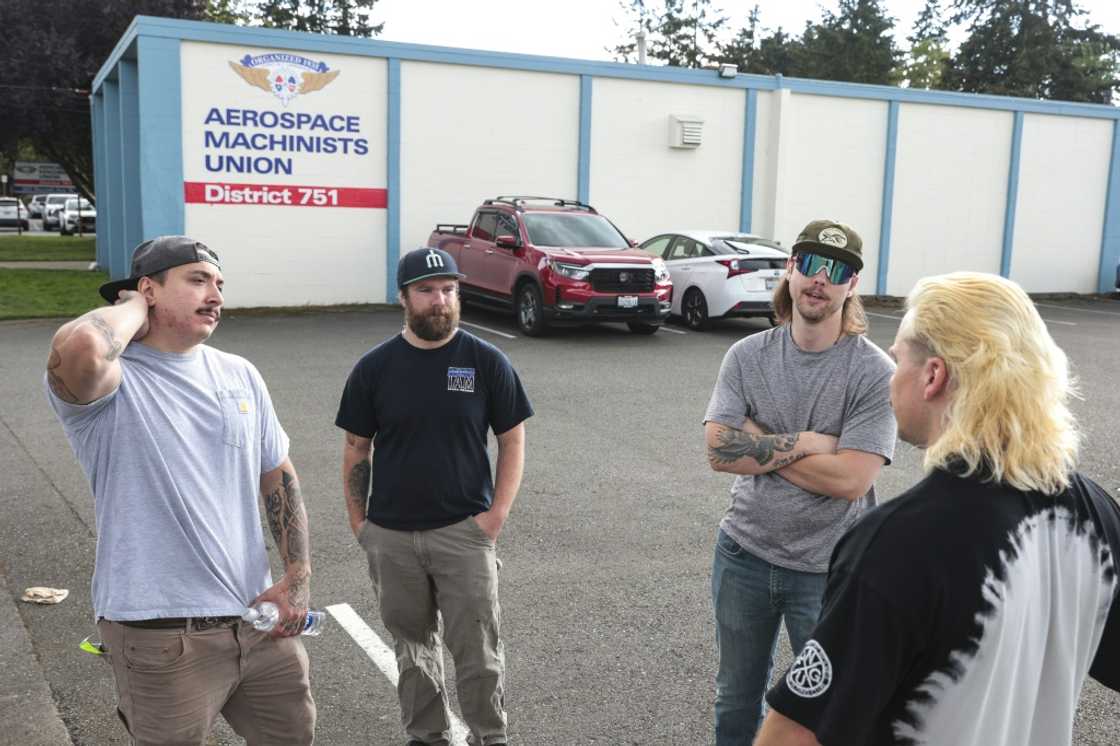 Boeing mechanics (from L) Nick Hudson, Joe Philbin, Blake Thayer and Ajay Fraatz gather outside after submitting their votes on whether to strike