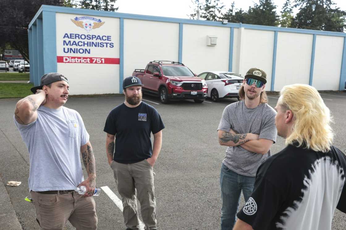 Boeing mechanics (from L) Nick Hudson, Joe Philbin, Blake Thayer and Ajay Fraatz gather outside after submitting their votes on whether to strike Boeing mechanics (from L) Nick Hudson, Joe Philbin, Blake Thayer and Ajay Fraatz gather outside after submitting their votes on whether to strike