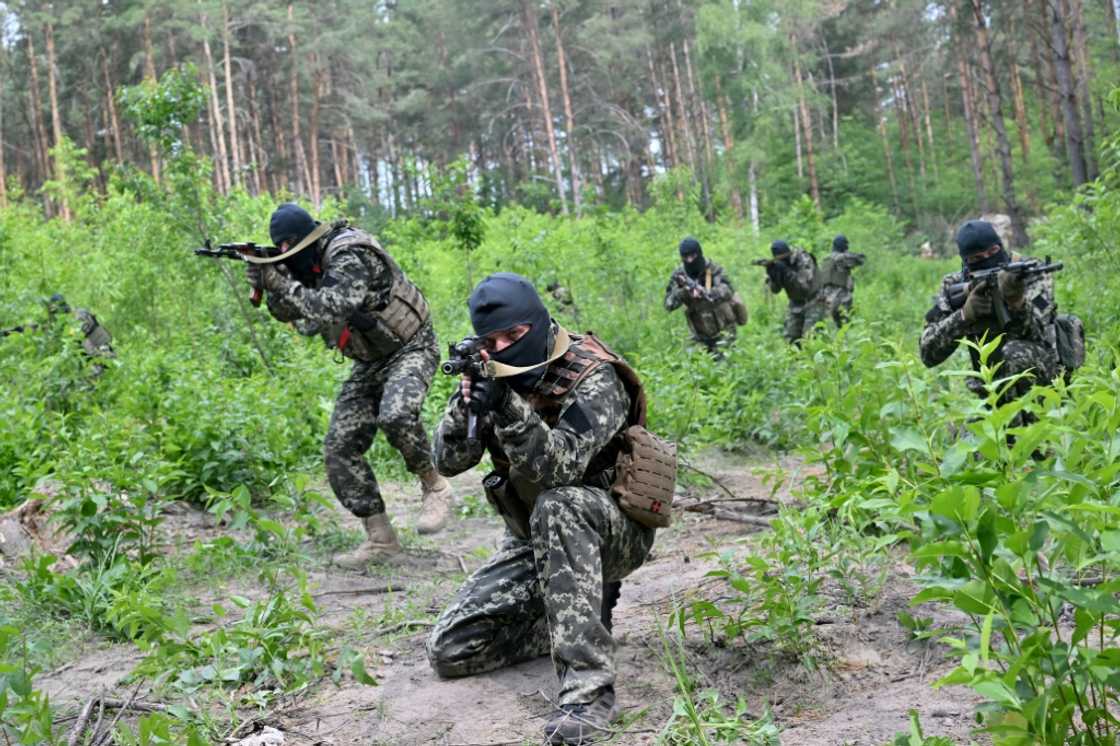 Fighters of Ukraine's territorial defense unit that supports the regular army take part in an exercise near the town of Bucha on June 17, 2022 Fighters of Ukraine's territorial defense unit that supports the regular army take part in an exercise near the town of Bucha on June 17, 2022
