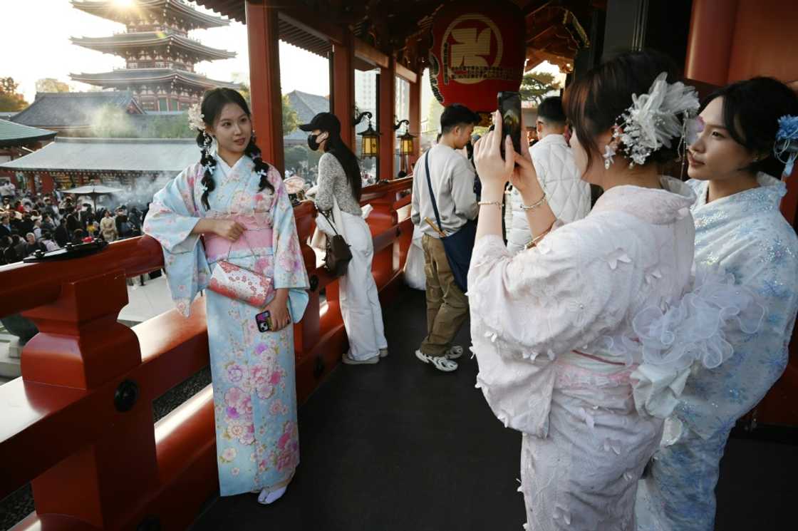 Chinese tourists wear kimonos as they visit the Sensoji Temple in Tokyo Chinese tourists wear kimonos as they visit the Sensoji Temple in Tokyo