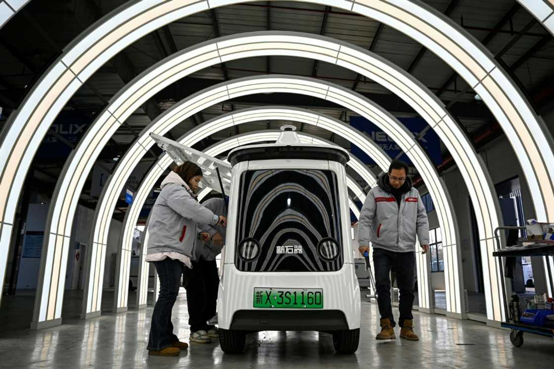 At the Neolix factory, 300 kilometres (186 miles) north of Shanghai, newly built driverless vehicles zoomed around a testing track simulating obstacles including puddles and bridges