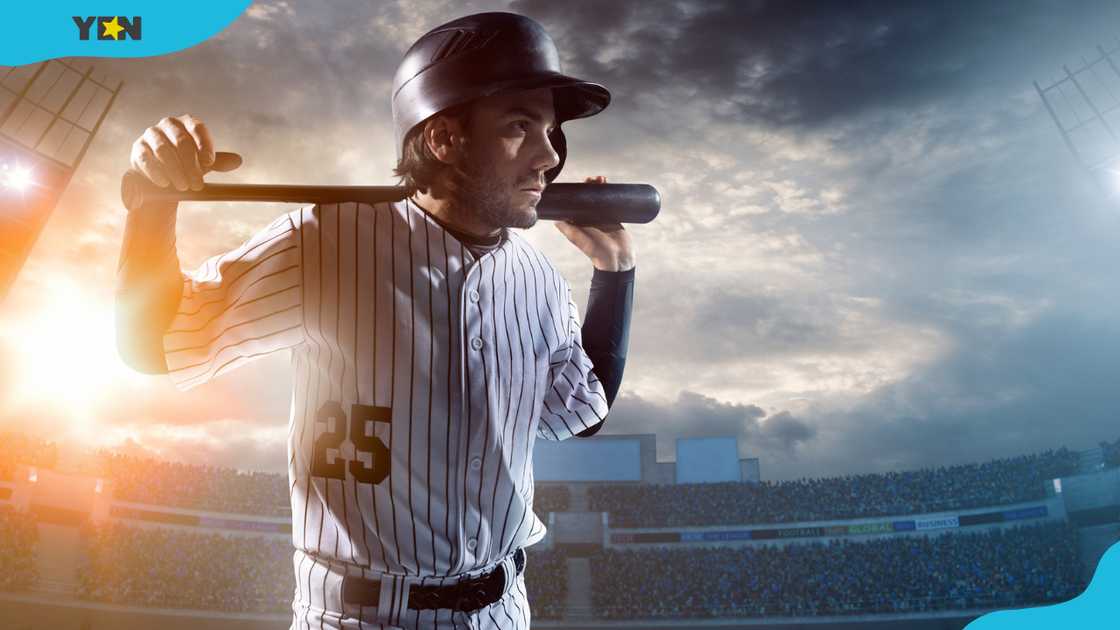 A player walking up to bat in a stadium A player walking up to bat in a stadium