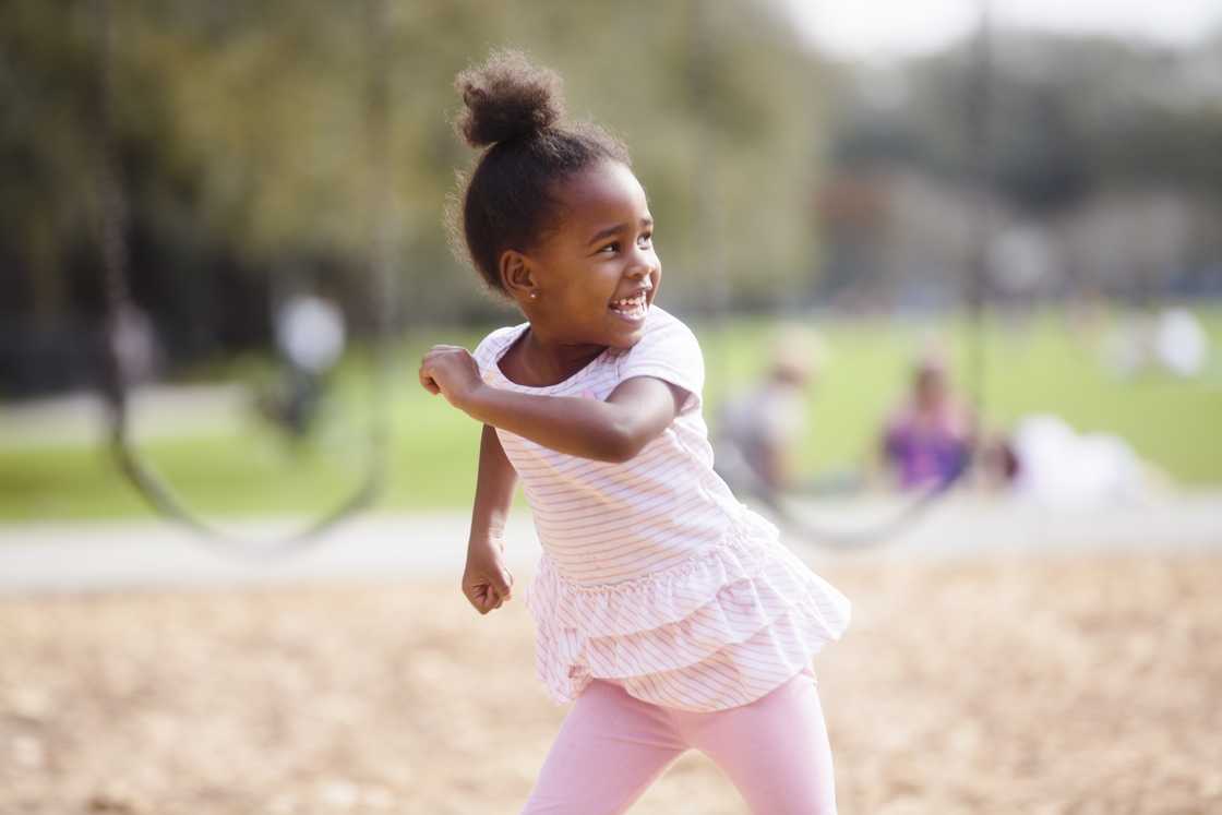 A young girl playing in the park A young girl playing in the park